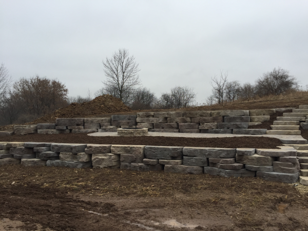 Large cut bolder retaining wall installation in Ozaukee County