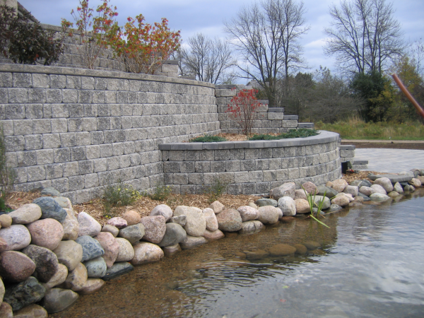 Steep stone brick retaining wall by water installer for Ozaukee County