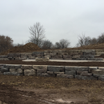 Large cut bolder retaining wall installation in Ozaukee County