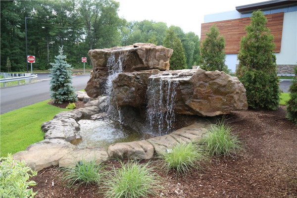 backyard and commercial lot waterfall design & installation in Ozaukee County