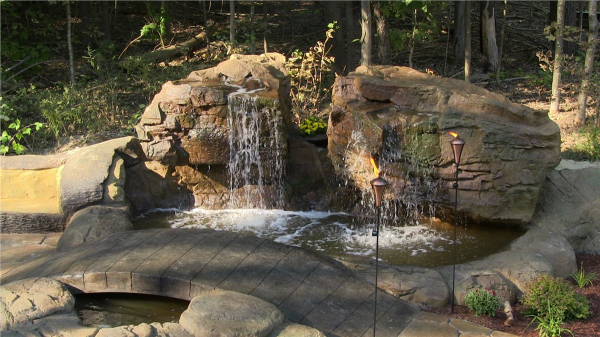 Backyard water feature installation in Mequon, waterfalls, water bridges, water slides